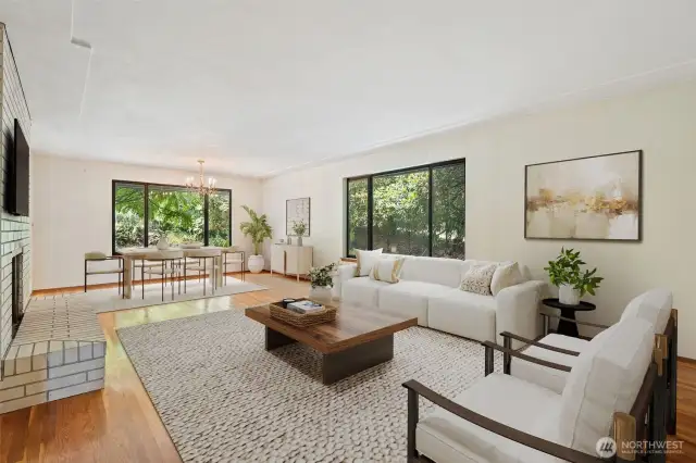 Large living room with picture windows to private backyard - gleaming original hardwood floors. Virtually staged to show potential of this space!
