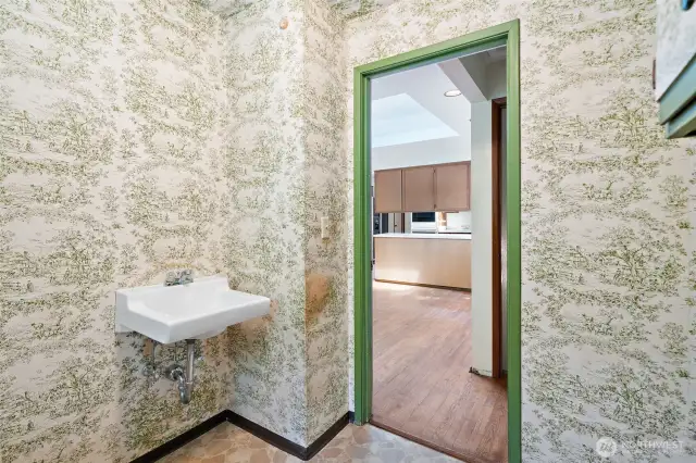 Hall half bath off kitchen eating area and next to the large bedroom - great opportunity to do a remodel and make the large bedroom into a suite by grabbing the small hall & door next to this bathroom - so much potential!