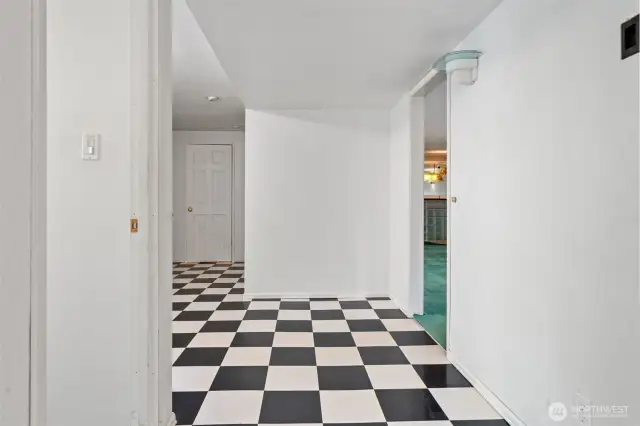 Lower level entry - currently used to access the home. Leads to bathroom, recreation room, storage or workout room, bedroom & 2 car garage.