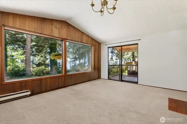 Front door enters into large living area with huge picture windows and access to the porch. *Tenant's furnishings have been digitally removed.*