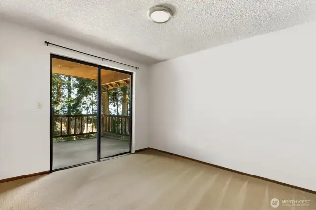 Primary bedroom has lots of closet space and more porch access. *Tenant's furnishings have been digitally removed.*