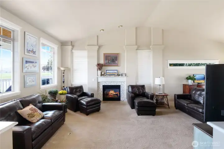 Cozy propane fireplace with tile surround anchors the living space