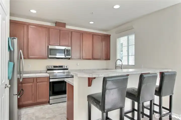 Nice sized kitchen with plenty of storage, a pantry, and eating space overlooking great room.