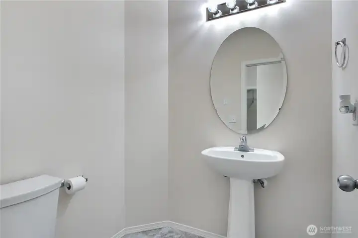 Main level half bath with elbow room.