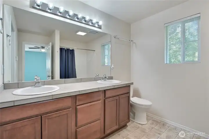 Primary bath has a 2 sink vanity and room for all your bathing needs.
