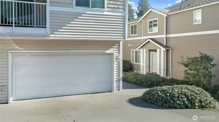 Two car garage with driveway parking for more cars, easy access.