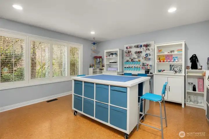 Main floor craft room with durable cork flooring overlooking the backyard. Creative inspiration happens here!