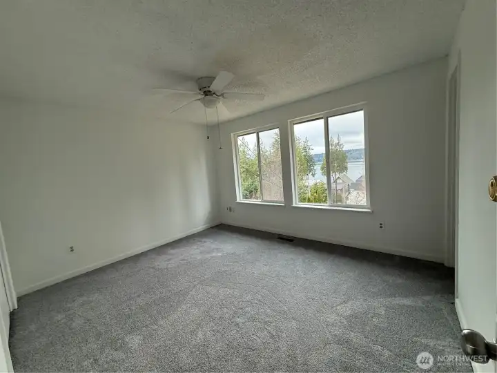 Primary bedroom with view of Hood Canal & Mountain. New carpet too