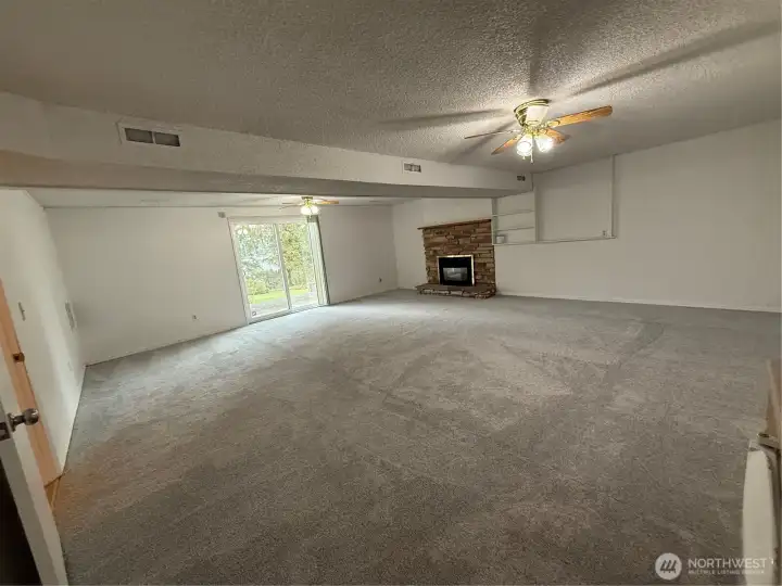 Lower level Familyroom with Fireplace and walkout access to front patio