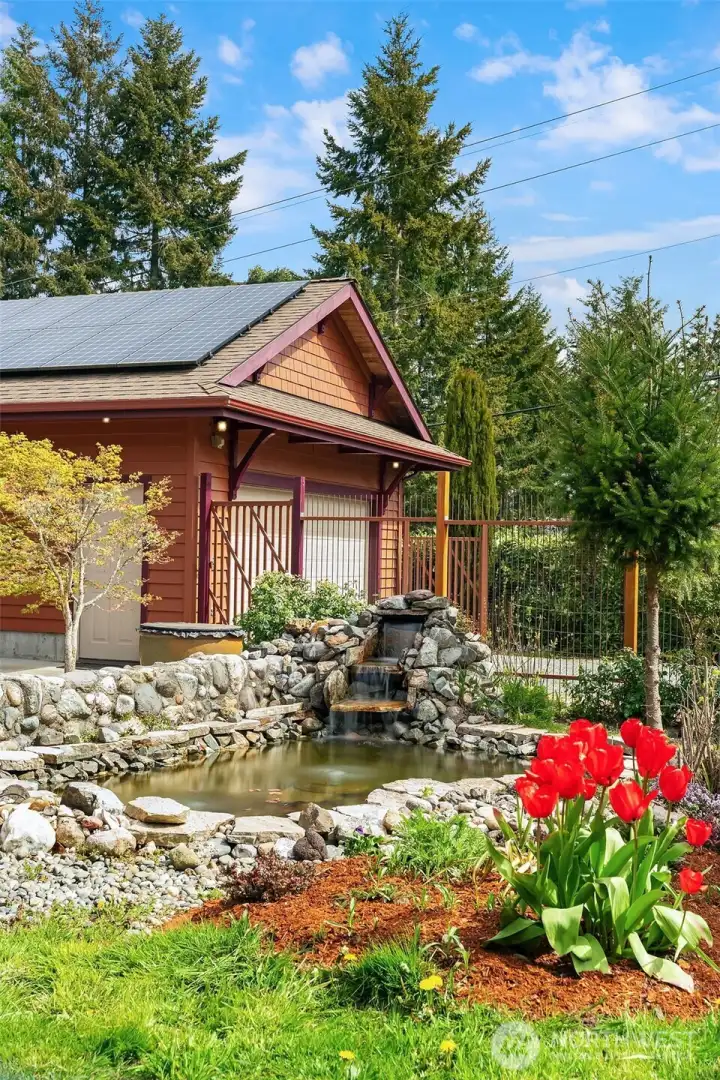 Lovely, fully fenced courtyard with pond and fountain greets you as you enter the property.