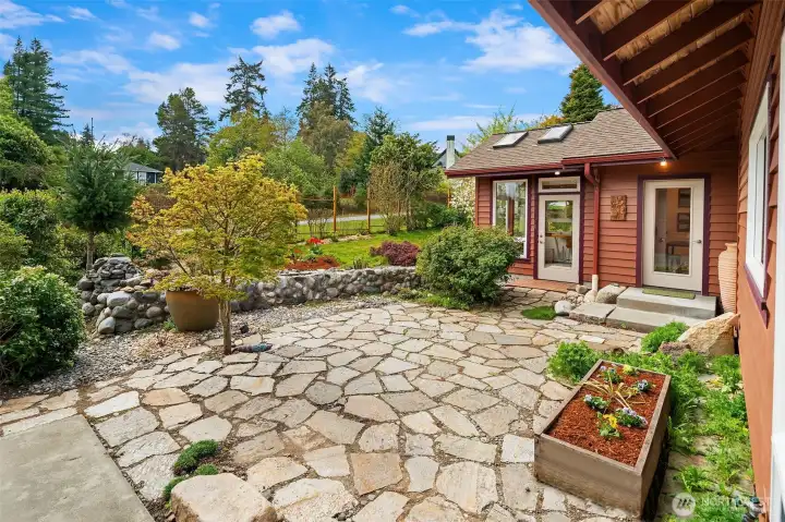 Entry courtyard with flagstones and mature landscaping. Conservatory and second bedroom both have direct access to courtyard.