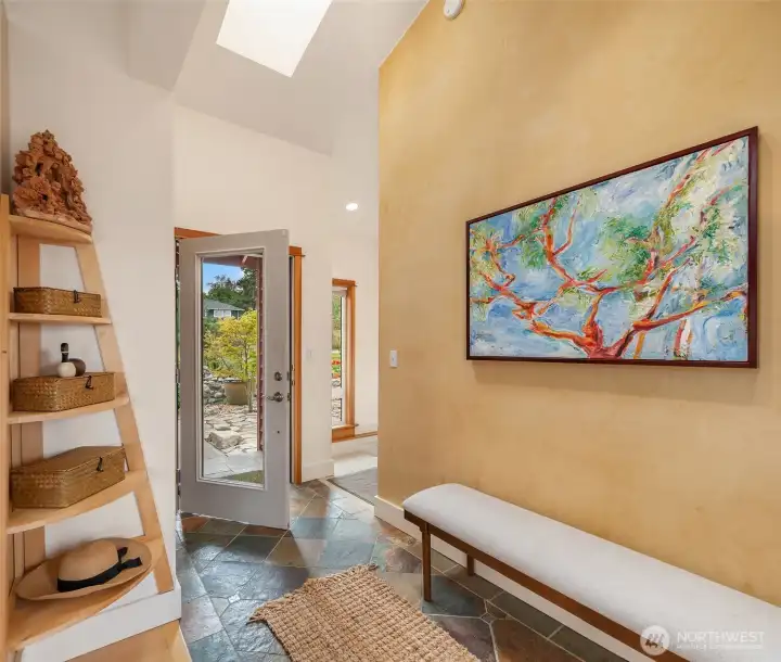 Welcome in! The entry features slate tile floors, skylight and true custom plaster wall. Gracious and inviting.