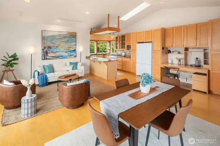 Open kitchen defines the southeast corner of the great room. Plenty of cabinetry, built in desk; all flooded with light all day long.