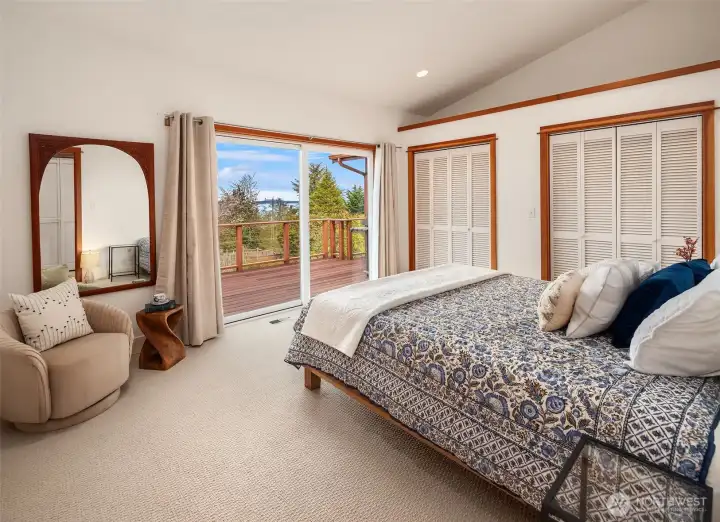 Down the hall from the great room, the primary bedroom has vaulted ceilings, new carpet, direct view deck access, ensuite bath and lots of closet space. A restful and beautiful space.