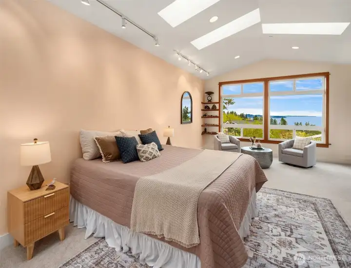 At the western end of the home lies this wonderful room with gorgeous views; large, bright with skylights and windows, with sitting area, direct access to the view deck, and conservatory on the south side.