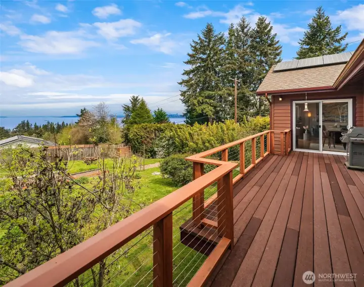 The view deck overlooks the orchard and veggie garden with access from the great room and the primary and secondary bedrooms. Summer evenings are perfect here! Gas hook-up for barbecue.