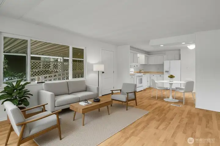 Looking back towards the cheery and bright kitchen, the living room is spacious enough for a variety of furniture configurations. *Virtually staged