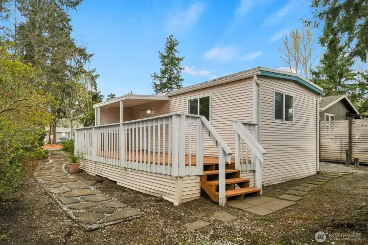 Back view of the home with stairs down from the rebuilt deck to your garden area. Room for your 'Green Thumb' to have fun!
