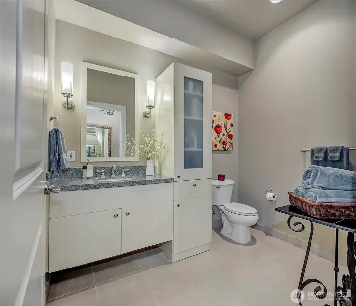 Main level full bath with linen storage makes for ease of living.