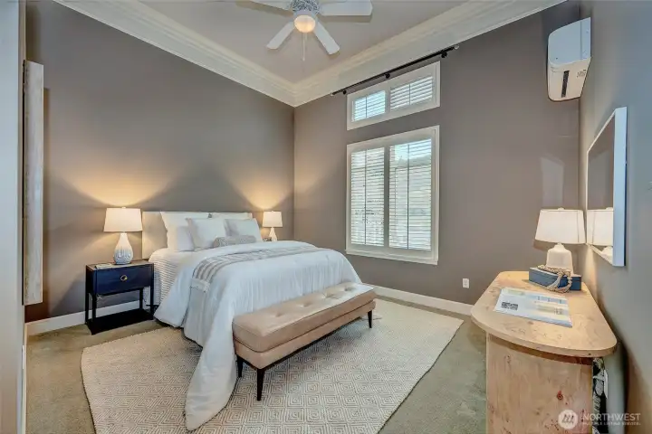 Gracious light filled Primary suite dressed in plantation shutters, custom crown moldings and 12' ceilings.