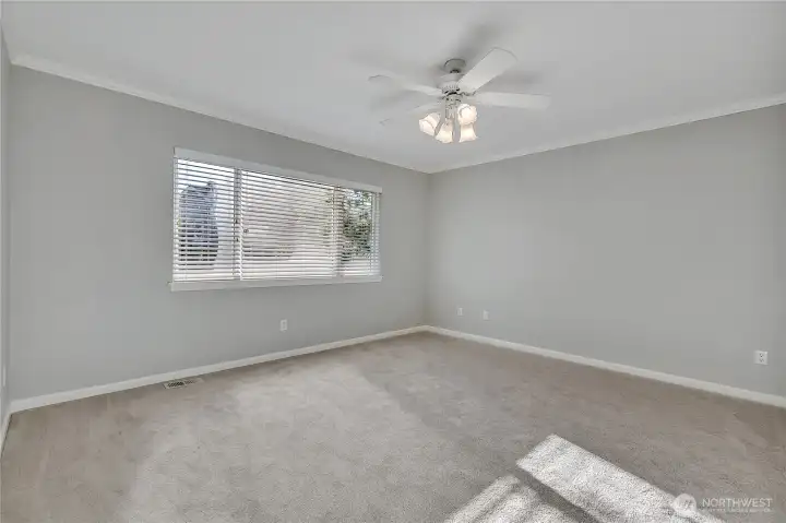 Master bedroom, the large window for natural light, molding ceiling and the ceiling fan with its overhead lighting.