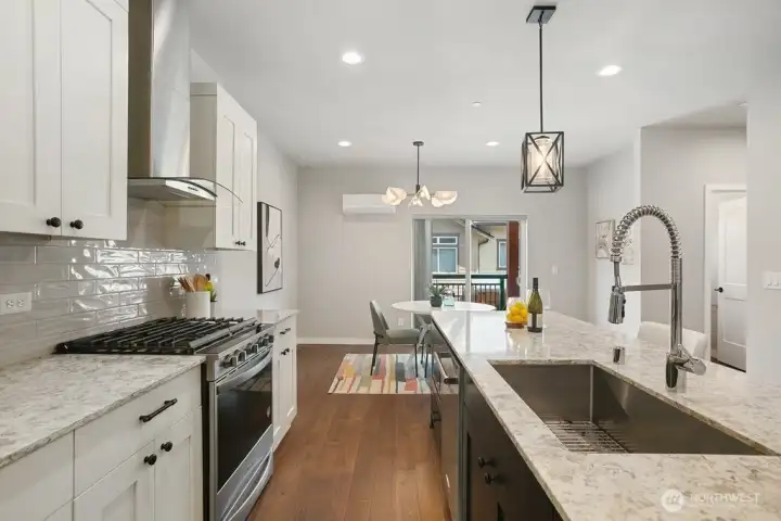 Stainless steel appliances with modern hood completes this versatile Chef's kitchen!