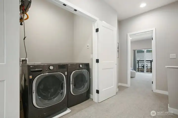 Laundry upstairs with newer washer and dryer.