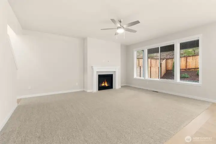 Great room featuring a cozy gas fireplace and lots of windows for natural light. Great room featuring a cozy gas fireplace and lots of windows for natural light.