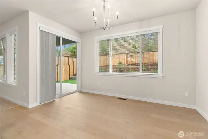 Dining room with slider opening to outdoor patio space. Dining room with slider opening to outdoor patio space.