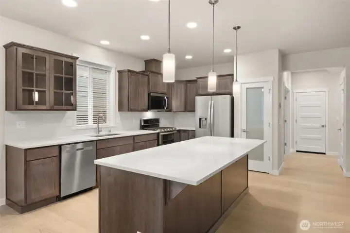 Great kitchen layout featuring Canyon Creek Maple cabinetry in Cocoa color with single-level island. Great kitchen layout featuring Canyon Creek Maple cabinetry in Cocoa color with single-level island.