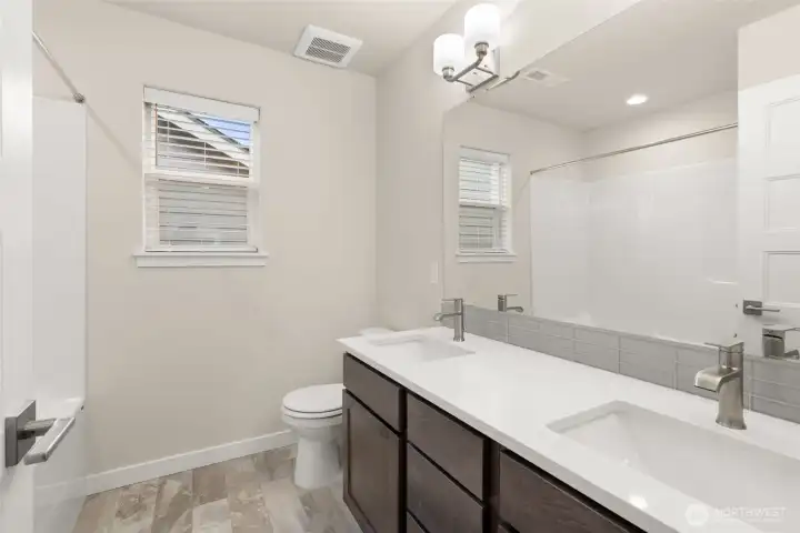 Upstairs full bathroom with double vanity and quartz countertops. Upstairs full bathroom with double vanity and quartz countertops.