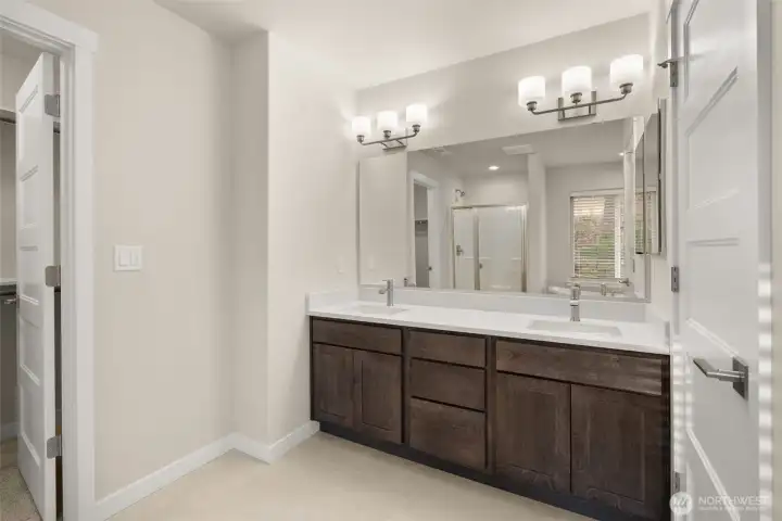 Primary bath with lots of storage in double vanity with quartz countertops and tile flooring. Primary bath with lots of storage in double vanity with quartz countertops and tile flooring.