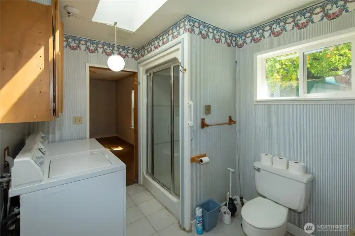 Primary bathroom showing laundry and shower Primary bathroom showing laundry and shower