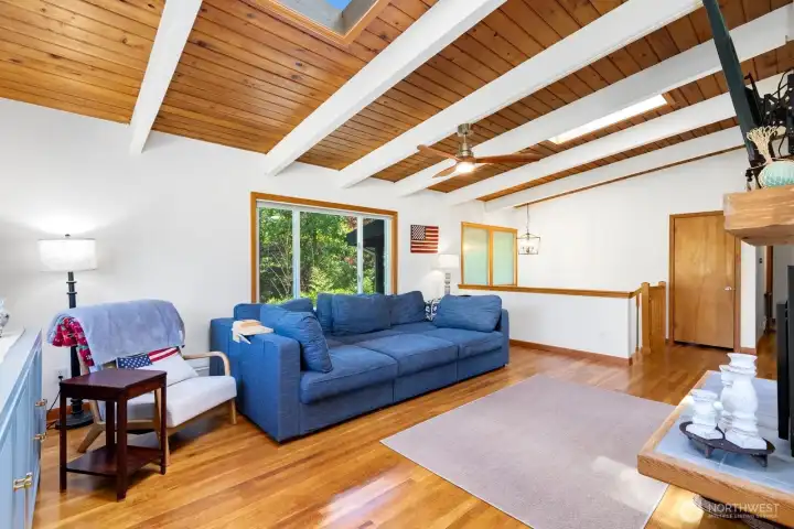 Skylights bring extra light to the airy great room. The entrance stairs are beyond the half-wall in the back right of the photo, with a convenient coat closet on the top landing. Skylights bring extra light to the airy great room. The entrance stairs are beyond the half-wall in the back right of the photo, with a convenient coat closet on the top landing.