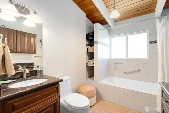 Updated main floor bathroom, serving guests and the secondary bedrooms. All three bathrooms feature radiant heated floors! Updated main floor bathroom, serving guests and the secondary bedrooms. All three bathrooms feature radiant heated floors!