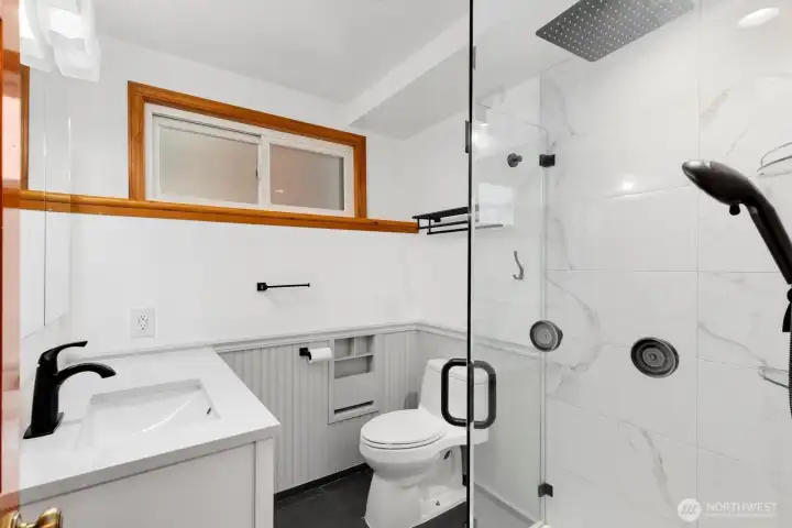 Updated 3/4 bath with a glass shower enclosure in the lower level. Updated 3/4 bath with a glass shower enclosure in the lower level.