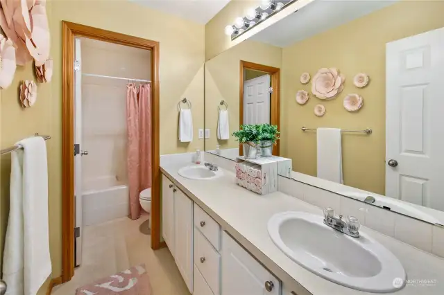 A great main hallway bathroom w/dual sinks and separate toilet and shower area.