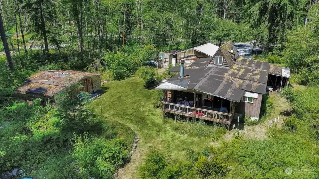 3 buildings - home on right, garage in front, extra room with storage on left