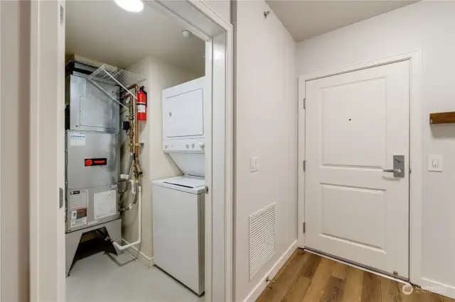 Utility closet with washer and dryer.