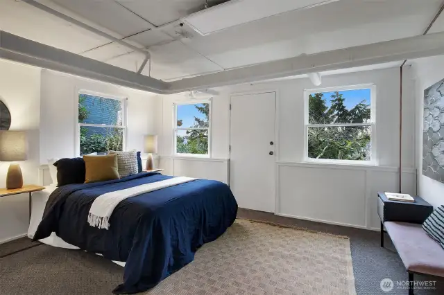 Daylight basement bedroom. Exterior door leads to backyard.