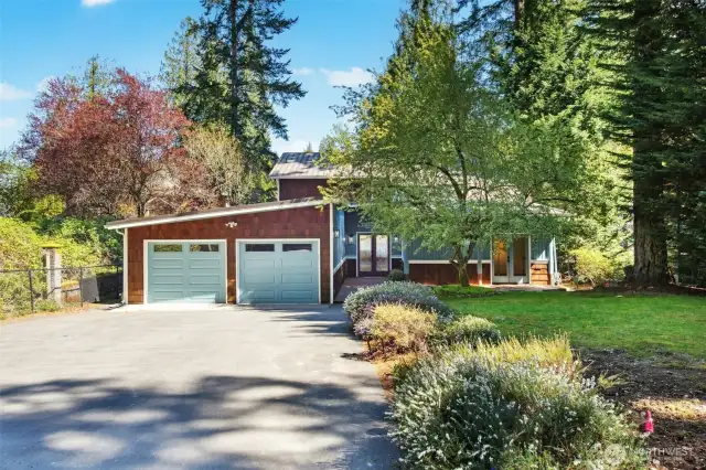 This 3-bed, 2-bath home is tucked into a private Pine Lake cove on a stunning 18,815 sq ft parklike lot