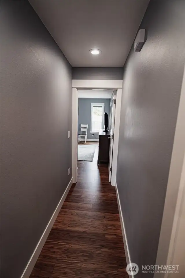 Hallway that goes to the primary bedroom on the back of the home.