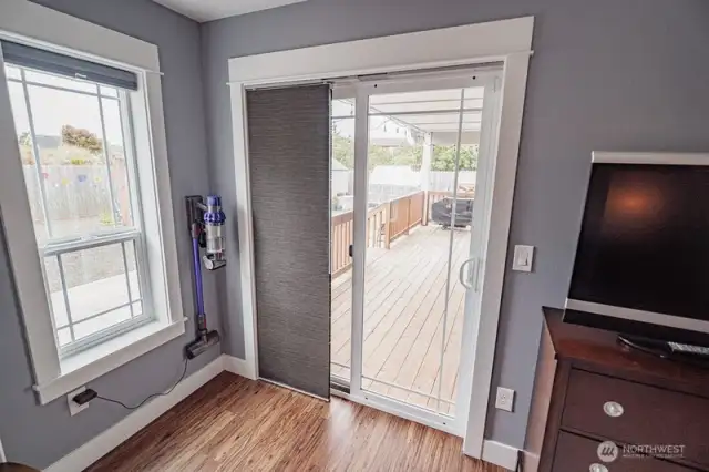 Sliding door in primary bedroom goes to a large covered deck.
