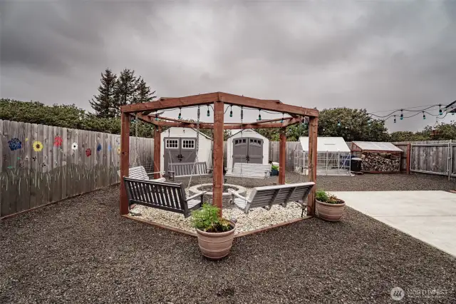 What a sweet sitting area with firepit. Notice the huge covered wood shed. You'll have plenty of wood for your upcoming fires.