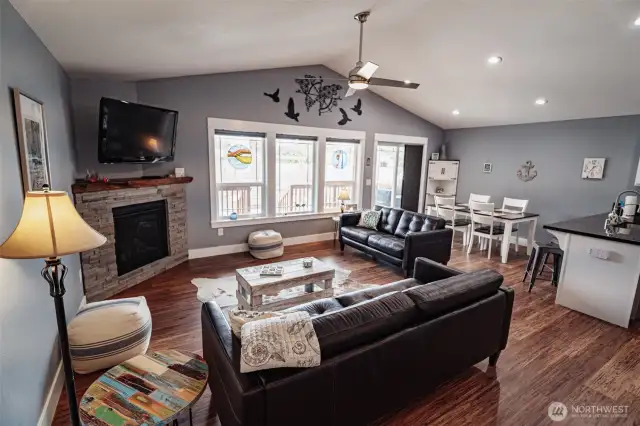 Walk into this lovely living room with vaulted ceiling and ceiling light and fan.