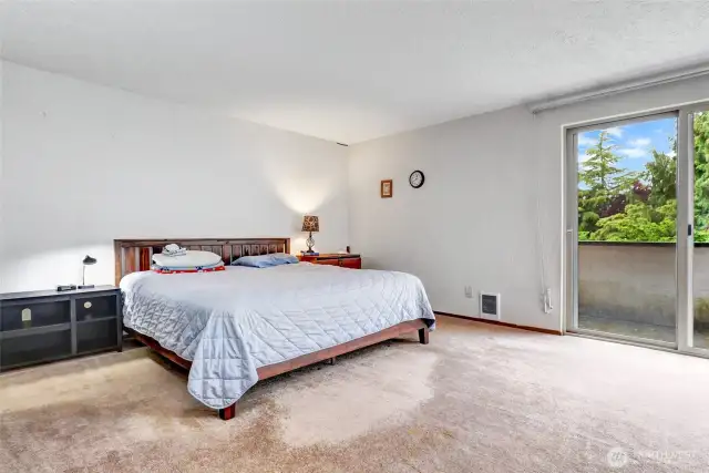 Spacious primary bedroom with double closets, private deck and en suite bath