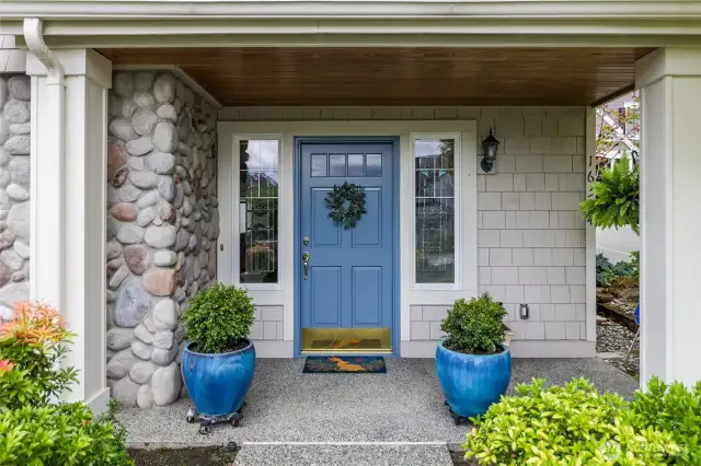 Stone wall at entry, containers, greenery, maintained by HOA
