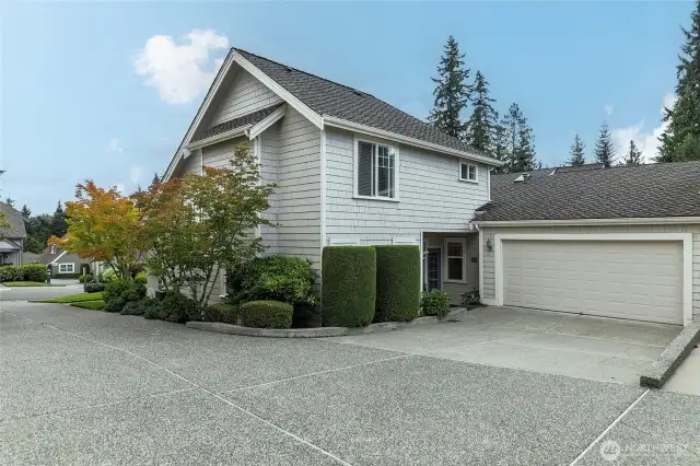 Back view of home, attached garage, driveway