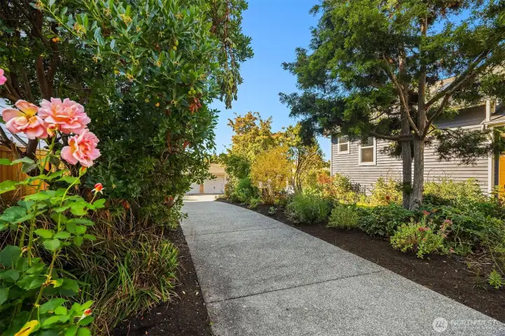 The home sets down a long (recently repoured) concrete driveway.  Offering wonderful privacy and lovely low maintenance landscaping.