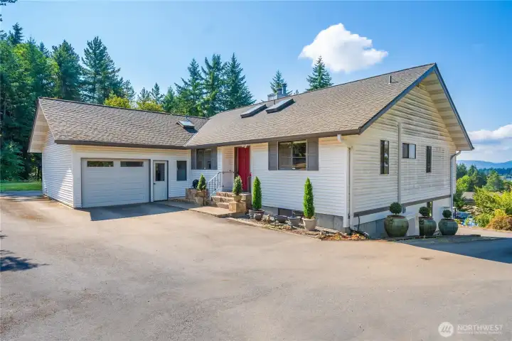 This home has a full circular driveway with plenty of parking. A garage up top and a 2 car garage below.